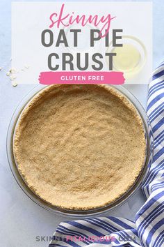 an oat pie crust in a pan on top of a blue and white striped napkin