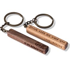 two wooden key chains with words on them