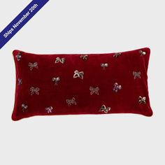 a red pillow with bows on it