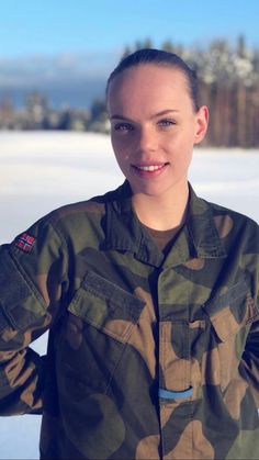 a woman in camouflage is posing for the camera