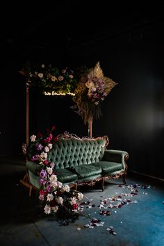 an old couch with flowers on the floor