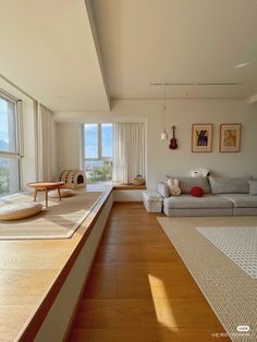 a living room with wood floors and white walls