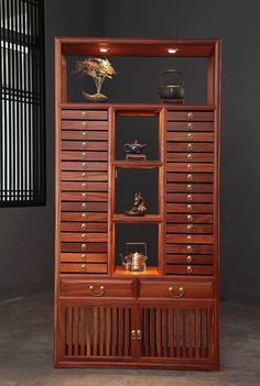 a large wooden cabinet with drawers and shelves