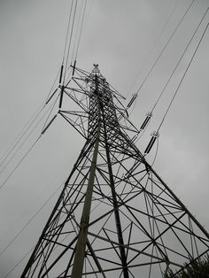 the top of an electric tower with many power lines above it on a cloudy day