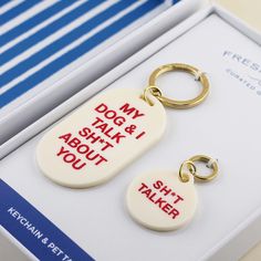 two keychains with the words don't say about you in red and white