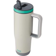 a white and green travel mug with handle