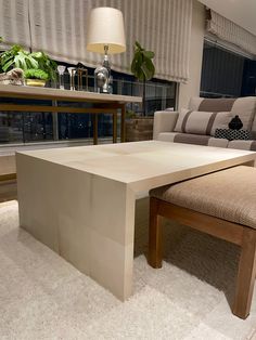 a living room with a couch, chair and table in the middle of carpeted flooring