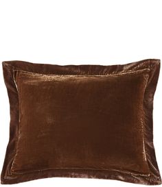 a brown velvet pillow on a white background