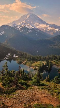 a view of a mountain range with a lake in the foreground