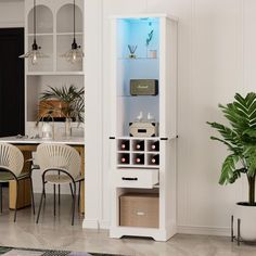 a white cabinet filled with lots of bottles next to a dining room table and chairs