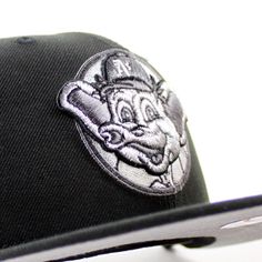 a baseball cap with a cartoon character embroidered on the front and side, along with a black visor