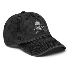 Embrace edgy style with the "Skull Crossbone" Vintage Cotton Twill Cap by GDS Label.  This embroidered cap features a classic skull and crossbones design, perfect for fans of gothic fashion, metal, punk, and biker aesthetics.  Made from durable cotton twill, this hat offers a comfortable fit with a vintage vibe that adds a rebellious touch to any outfit.  Whether you're channeling pirate energy or simply love bold, alternative fashion, this cap is an essential piece for those who dare to stand out. * 100% cotton twill * 6-panel unstructured cap with a low profile * 6 sewn eyelets * Black sweatband * Metal snap buckle with an antique brass finish * Washed-out vintage effect * Blank product sourced from China This product is made especially for you as soon as you place an order, which is why Gothic Mode, Punk Pirate, Skull Crossbones, Embroidered Cap, Vintage Skull, Embroidered Caps, Edgy Style, Skull And Crossbones, The Skull