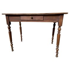 an old wooden table with two legs and a drawer on the top, against a white background