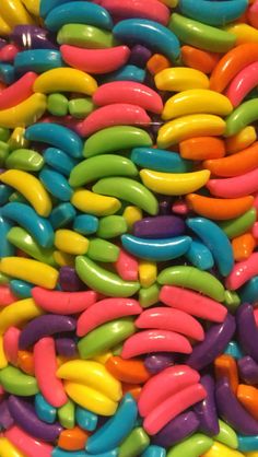 there are many different colored candy beans in this pile, and one is multicolored