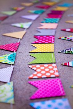 the colorful flags are laid out on the floor to be used as decorations or wall hangings