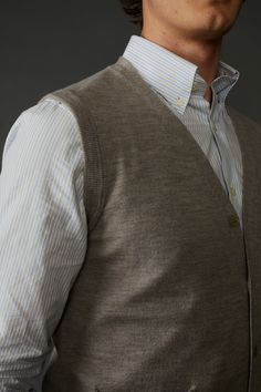 Introducing our Extra Fine Merino Wool Cardigan Vest for Men, made from New Zealand/Australian merino wool. The classic design of the cardigan features a ribbed collar and pockets. The vest is available in a variety of colors that are perfect for layering under our sportcoats. (Ask us for the perfect color to compliment any of our sportcoats). Whether you're dressing up or dressing down, this Extra Fine Merino Wool Cardigan Vest for Men is a must-have addition to your wardrobe. 100% Extra Fine M Classic Business Vest For Winter, Classic Wool Winter Vest, Classic Wool Vest For Winter, Winter Classic Wool Vest, Classic Winter Cardigan With Welt Pockets, Classic Winter Sweater Vest With Pockets, Classic Outerwear With Pockets, Fitted Classic Cardigan For Layering, Classic V-neck Outerwear For Business