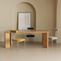 a wooden table with two chairs next to it and a framed photograph on the wall