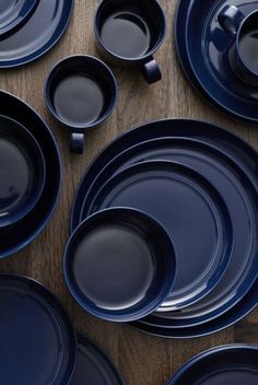 blue dishes are arranged on a wooden table