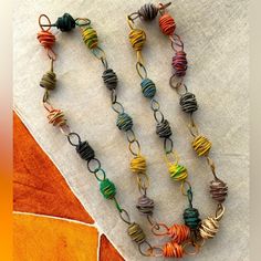 a long necklace with multicolored spirals on it