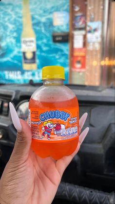 a person holding up a bottle of chubby juice