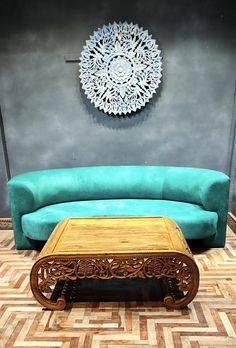 a green couch sitting next to a wooden coffee table