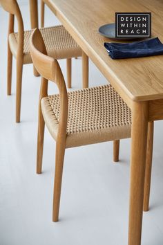 a wooden table with four chairs and a sign that says design within reach on it