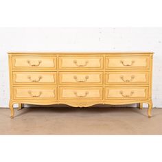 an old yellow dresser with many drawers