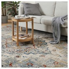 a living room with a couch, coffee table and rug