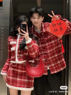 a man and woman dressed up in costumes taking a selfie with a cell phone