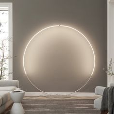 a living room filled with furniture and a large circular light on the wall above it