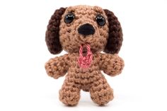 a crocheted dog with a pink heart on it's chest