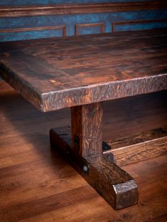 a wooden table sitting on top of a hard wood floor