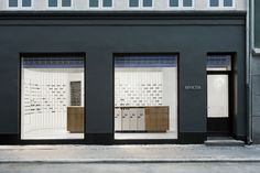 an empty storefront with two doors and windows on the side of the street in front of it