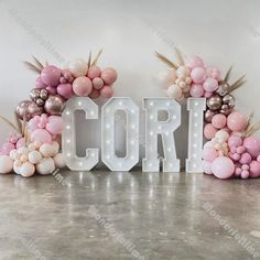 some balloons and letters that spell out the word corri in front of a white wall