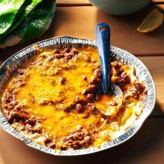 a bowl filled with food sitting on top of a wooden table