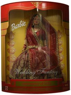 a barbie doll in a red and gold wedding dress with veil on it's head