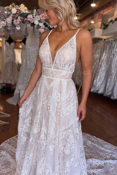 a woman in a white dress standing on a floor