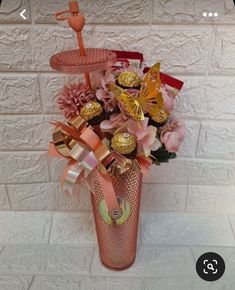 a vase filled with assorted candy and flowers