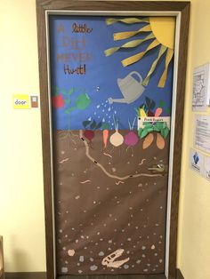 a door decorated to look like a dirt never hurtd scene with an image of a watering can