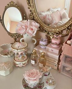 there is a vanity with pink roses and other items on the table next to it