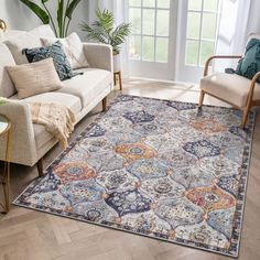 a living room with a couch, chair and rug