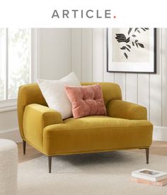 a yellow chair with some pillows on it