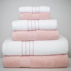 towels stacked on top of each other in pink and white