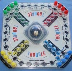 a close up of a board game on a blue tablecloth with buttons and letters