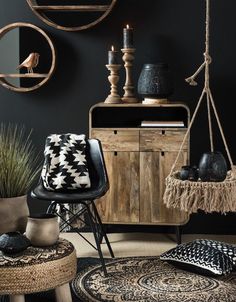 a living room with black walls and wooden furniture in the corner, including a chair