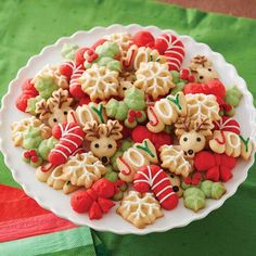 a plate full of decorated christmas cookies on a table