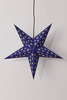 an origami star hanging on a wall