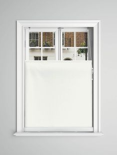 an open window with a white curtain on it