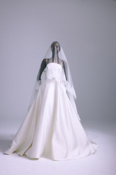 a woman in a white wedding dress and veil