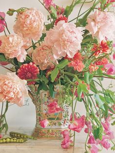 a vase filled with pink flowers on top of a table